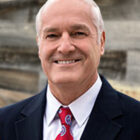 Bio image of Thomas W Mitchell smiling