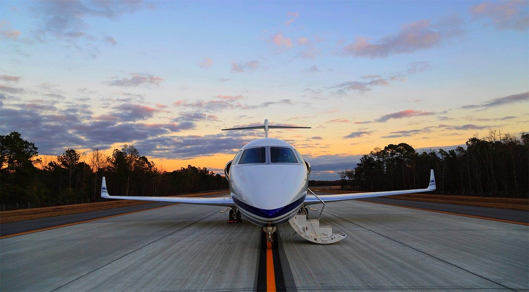 private jet on runway with stairs in the open position.